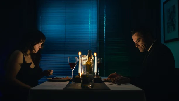 MAYA film still showing two people seated at a candlelit table
