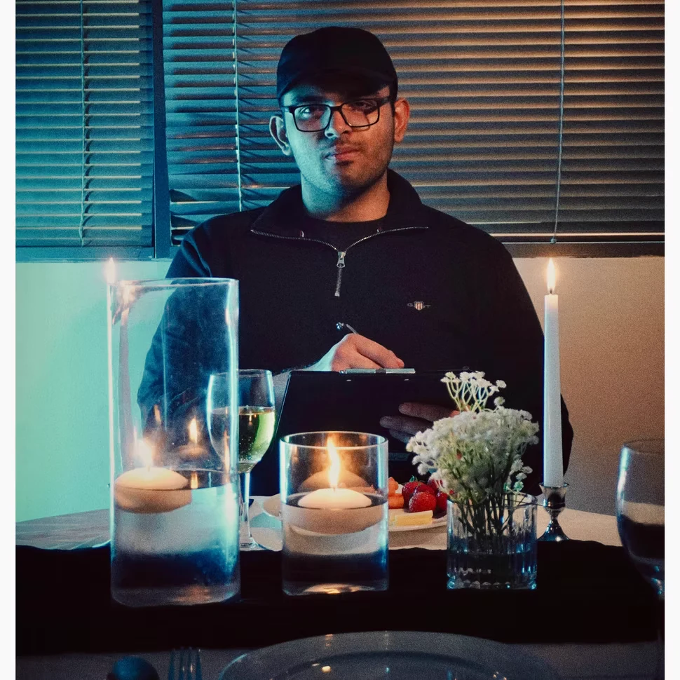 Karan Paitka seated at a candlelit film set